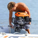 Aqua-Marina-U-Deluxe-inflatable-boat-man-attaching-outboard-motor