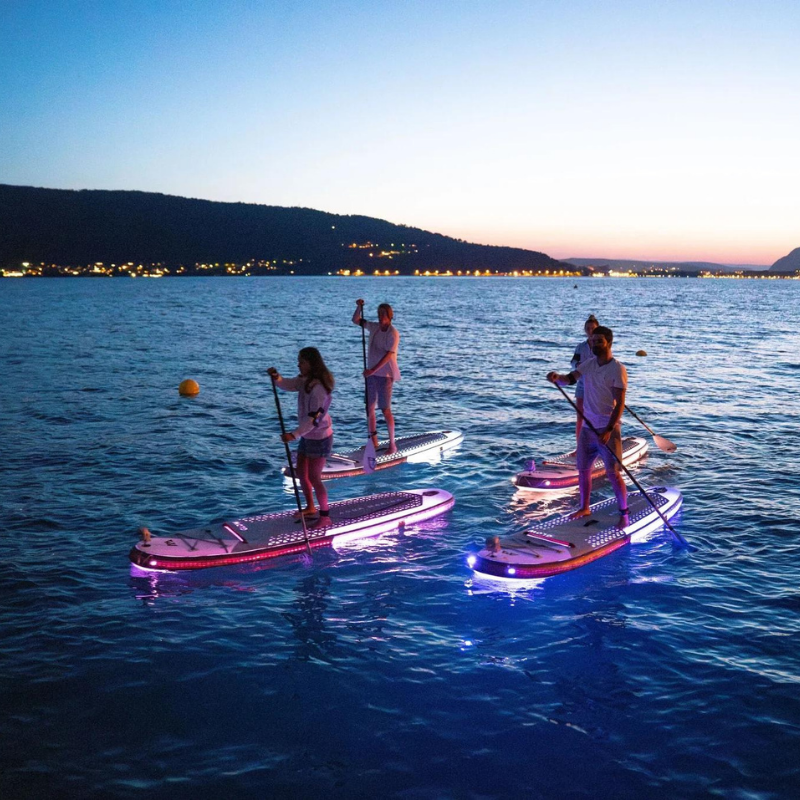 aqua-marina-glow-inflatable-paddleboard-with-light-system-paddlers-on-water